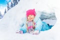 Little girl crawl through snow tunnel in park Royalty Free Stock Photo