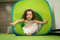 Little girl crawls inside toy tunnel at childrens holiday