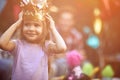 Little girl with crown at head playing at  birthday party Royalty Free Stock Photo