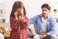 Little girl crying after arguing wIth dad, angry father behind Royalty Free Stock Photo