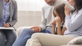 Little Girl Crying In Children Psychologist`s Office, Caring Parents Comforting Her