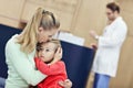 Little girl is crying while with her mother at a doctor on consultation Royalty Free Stock Photo