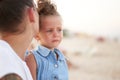 Little girl crying Mother daughter summer beach. Child upset and cry