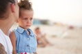 Little girl crying Mother daughter summer beach. Child upset and cry