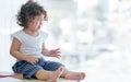 Little girl crying while sitting on table Royalty Free Stock Photo