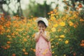 Little girl crying in yellow cosmos flower blooming field