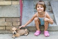 Little girl cuddle a puppy