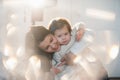 Little girl cuddling with her mother in a nice winter clothes, baby, lifestyle, childhood, joy, family values, life style