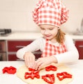 Little girl cuts dough with form for cookies Royalty Free Stock Photo