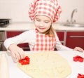 Little girl cuts dough with form for cookies Royalty Free Stock Photo