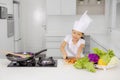 Little girl cutting a carrot in the kitchen Royalty Free Stock Photo