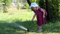 Little girl dabbles with Sprinkle in the park