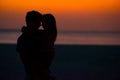 Little girl and dad silhouette in the sunset at the beach Royalty Free Stock Photo