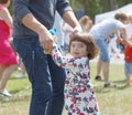 Little girl dancing with her father around the Maypole, celebrating the Midsommer in Sweden