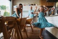 Little girl dancing in the kitchen, while parents watching her. Royalty Free Stock Photo