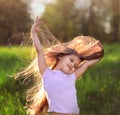 Little girl dancing in nature in summer with long hair