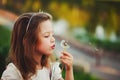 Little girl with dandelion in park