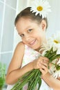 Little girl with dasies flowers