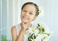 Little girl with dasies flowers