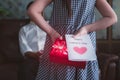 Little girl daughter holding and hiding greeting card for father behind back.Concept of Happy father`s day Royalty Free Stock Photo