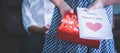 Little girl daughter holding and hiding greeting card for father behind back.Concept of Happy father`s day Royalty Free Stock Photo