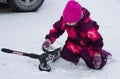 A little girl decided to ride a scooter, but in the morning it snowed again