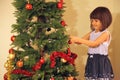 Little girl decorates Christmas tree Royalty Free Stock Photo