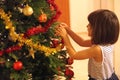 Little girl decorates Christmas tree Royalty Free Stock Photo