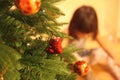 Little girl decorates Christmas tree Royalty Free Stock Photo