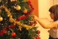 Little girl decorates Christmas tree Royalty Free Stock Photo