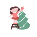Little girl decorates Christmas tree