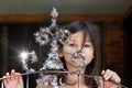 Little girl decorates the gate of the house