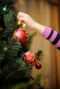 Little girl decorating the Christmas tree