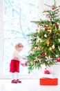 Little girl decorating Christmas tree