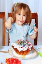 Little girl decorating easter cake Royalty Free Stock Photo