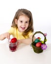 Little girl decorating traditional Easter egg