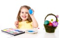 Little girl decorating traditional Easter egg