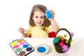 Little girl decorating traditional Easter egg