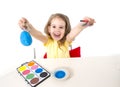 Little girl decorating traditional Easter egg