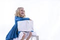 Little girl in a delightful mood with a gift, white box on a white background. Royalty Free Stock Photo