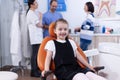 Little girl in dendistiry office showing milk tooth Royalty Free Stock Photo