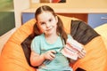 A little girl in a dental clinic holding a dental dummy Royalty Free Stock Photo