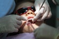 Little Girl on Dentist Chair, Kid is taking Dental Procedure