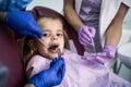 Little girl at dentist office. Looking at camera. Royalty Free Stock Photo