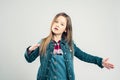 Little girl depicts a robot. child poses in the studio and makes movements with his hands and feet. kids fashion Royalty Free Stock Photo