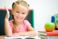 Little girl at the desk raised her hand Royalty Free Stock Photo