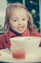 Little girl with dirty mouth eating fries and tomato Royalty Free Stock Photo