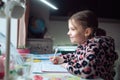 Little girl at distance home schooling, study lessons on quarantine