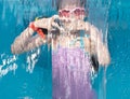 A little girl dives into a pool with glass walls, shooting through the pool glass. Pouring water from above. Royalty Free Stock Photo