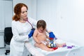 Little girl at doctor for checkup. Doctor pediatrician and baby patient. Child patient at doctor appointment Royalty Free Stock Photo